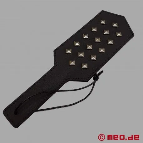 BDSM paddle made of leather with rivets